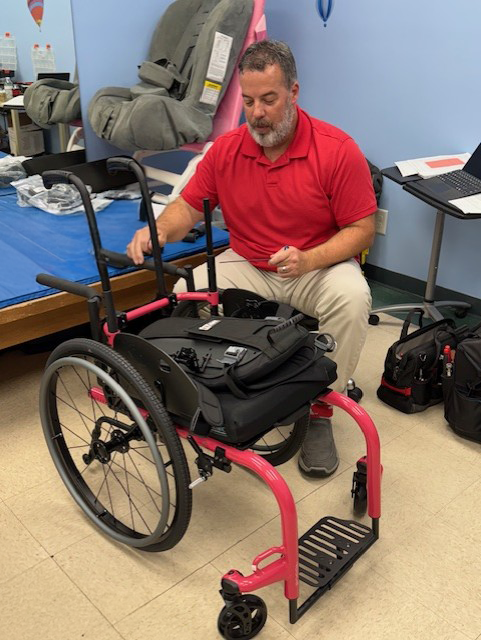 man looking at wheelchair