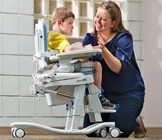boy and mom in adaptive chair