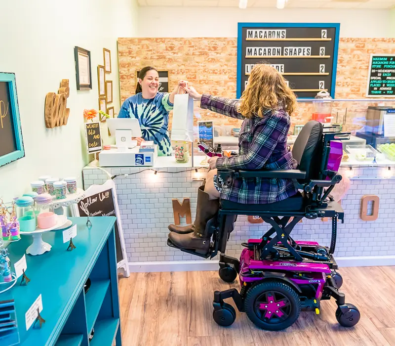 smiling girl in wheelchair in bakers